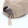 A beige cotton cap featuring a buckle strap closure and an inside branding label.