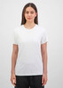 A short sleeve tee in white, featuring a crew neckline and a fitted style, displayed by a model.