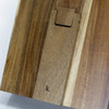 A wooden recipe book holder featuring a smooth finish and a branding logo, showcasing rich brown tones.