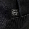 A black duffle bag made from recycled ocean plastic, featuring a small logo tag.