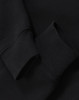 A black half-zip collar fleecy sweat featuring a close-up of the cuff detail. It includes a branding logo.