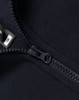 A close-up of a navy 1/2 zip collar fleece sweatshirt featuring a zipper and a tag.