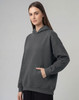 An unisex premium fleece oversized hoodie in grey featuring a front pocket and a drawstring hood.