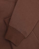 A brown unisex premium fleece oversized hoodie with ribbed cuffs and a soft finish. It features a logo.