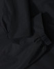 A waterproof jacket in black featuring elasticated cuffs and a durable fabric. The jacket has a logo present.