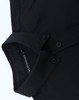 A black cotton blend long-sleeve shirt with a collar and button details, featuring a logo tag.