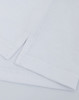 A close-up of a white cotton/poly pique fabric with folded edges, featuring a logo on the corner.