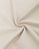 A close-up of beige cotton/polyester pique fabric, showcasing its texture and weave.