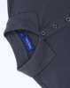 A dark grey ladies' classic cotton/poly pique short sleeve polo featuring a collar and button detail with a tag.
