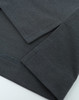 A close-up view of a grey polo shirt showcasing the fabric and stitching details. It features short sleeves and a logo.