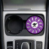 A round lavender air freshener sits in a car cup holder, featuring a logo in the centre.