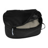 A black compression packing cube with a zippered opening, containing folded clothing inside.