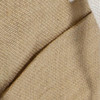 A close-up of a textured beige cooler bag with a contrasting light beige section and a logo.