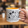A coffee mug with a vibrant orange interior, decorated with various coffee-related designs and a branding logo.