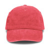 A vintage washed cap in a vibrant coral shade, featuring a curved brim and a logo on the front.