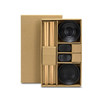 A keepsake sushi set featuring wooden chopsticks, black ceramic bowls, and soy sauce dishes in a cardboard box.