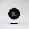 A white mobile phone stand with a black circular base featuring a logo. The design is sleek and modern.