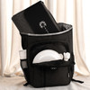 A black picnic backpack with a grey blanket, plates, cutlery, and a drink bottle in external pockets.