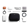 A black tech kit containing a range of accessories, including a charger, cables, and a portable hard drive.
