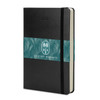 A black Moleskine 2027 planner with a decorative band featuring green foliage patterns.