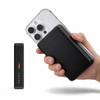 A black solid state power bank being held alongside a smartphone, featuring a sleek design and minimalistic branding.