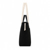 A black tote bag with cream straps and a drawstring closure. The bag has a simple design and features a logo.