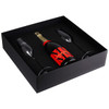 A black gift box containing a bottle of champagne and two elegant glass flutes.