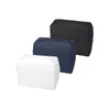 Three toiletry bags in black, navy blue, and white, featuring a zip closure and a logo.