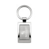 A silver keytag with a rectangular frame and a circular keyring, featuring a branded logo.