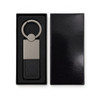 A sleek silver keytag with a leather strap, displayed in a black gift box.