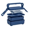 A navy blue double tray lunchbox with a handle, two stacked containers, and included cutlery. Contains a branding logo.