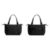 A black tote bag with two handles, featuring a sleek design and a logo. It appears in two angles.