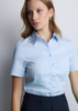 A light blue short sleeve shirt with a classic collar and buttons, featuring a logo on the chest.