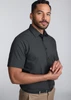 A classic fit short sleeve shirt in dark grey, featuring a button-up design. The model stands with a neutral expression.