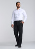 A classic fit long sleeve shirt in white, paired with black trousers, worn by a man standing confidently.