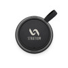 A black circular speaker with a textured edge and a strap, featuring a simple logo in the centre.