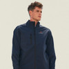 A softshell jacket in navy blue featuring zippered pockets and a logo.