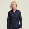A women's button-up denim shirt in dark blue with a pocket and a branded logo.