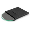 A round glass coaster in a black packaging, featuring a smooth surface and a subtle green tint.
