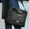 A dark grey laptop bag with black accents, featuring a shoulder strap and a logo.