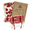 A wooden model of a cow in red and cream, featuring anatomical cuts, accompanied by two instructional booklets.