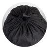 A black puffer blanket is rolled up and secured with a drawstring at the top. It has a smooth, shiny texture.