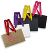 Four small paper bags in various colours—brown, white, black, and purple—featuring ribbon handles and logos.