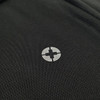 A close-up of a black polo shirt featuring a logo on the chest area.