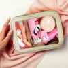 A peony cosmetic bag containing various pink beauty products, including lipsticks and applicators, with a clear window and branding.