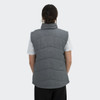 A women's puffer vest in grey with a high collar and quilted design, featuring a logo on the back.