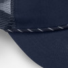 A navy trucker cap featuring a mesh back and a decorative striped band along the brim.