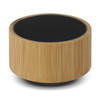 A bamboo Bluetooth speaker with a round design and black speaker mesh on top. It has a natural wood finish.