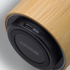 A bamboo Bluetooth speaker featuring a sleek design with a USB charging port on the base.