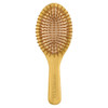 A bamboo hairbrush with a wooden handle and bristle pins, featuring a smooth oval design in natural tones.